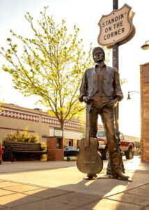 a statue of a man holding a guitar