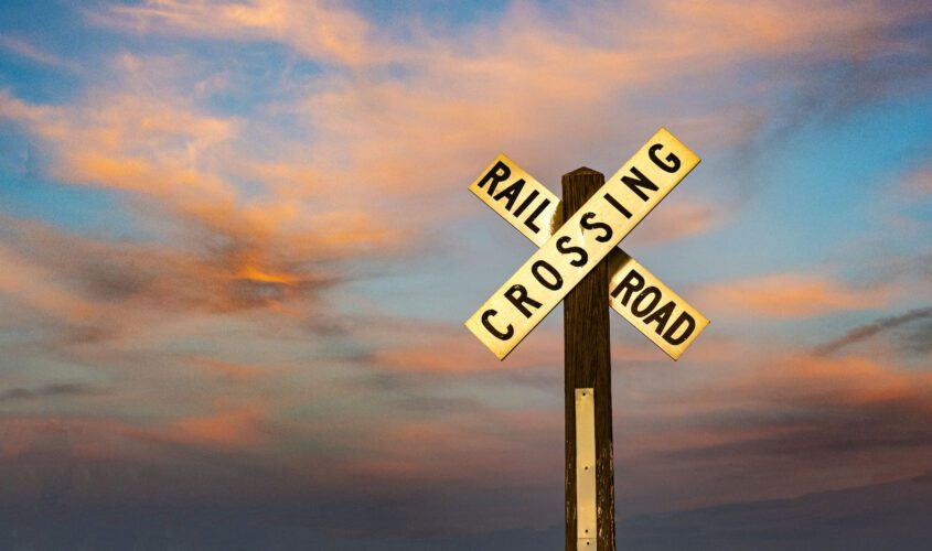 Colorful sky behind a railroad crossing sign near our Winslow, AZ lodging