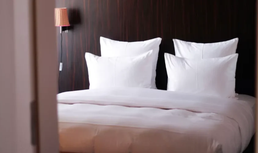 4 pillows neatly arranged on a bed at our pet friendly hotel in Winslow, AZ