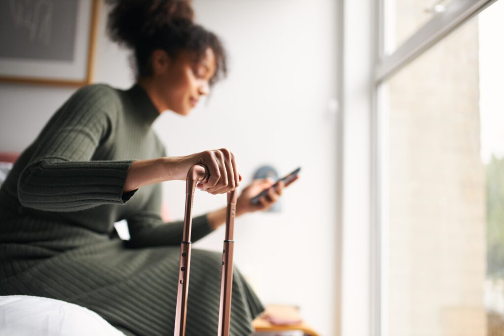 Woman with a suitcase checking her phone