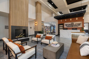 a large lobby with a fireplace and seating area