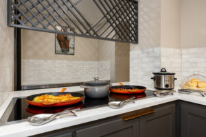 a kitchen with a stove top and a bowl of food on the stove