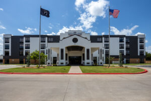 a large white building with a flag on top of it