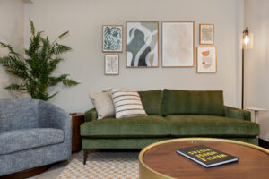 a living room with a green couch and a coffee table