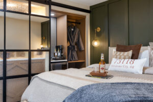 a bed with a bottle of beer on it