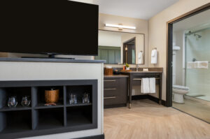 a bathroom with a television and a large mirror