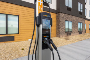 an electric car charging in front of a building