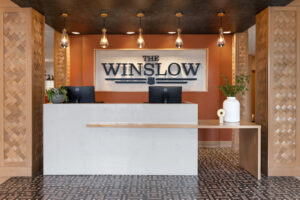 a reception area with a white counter and black and gold accents