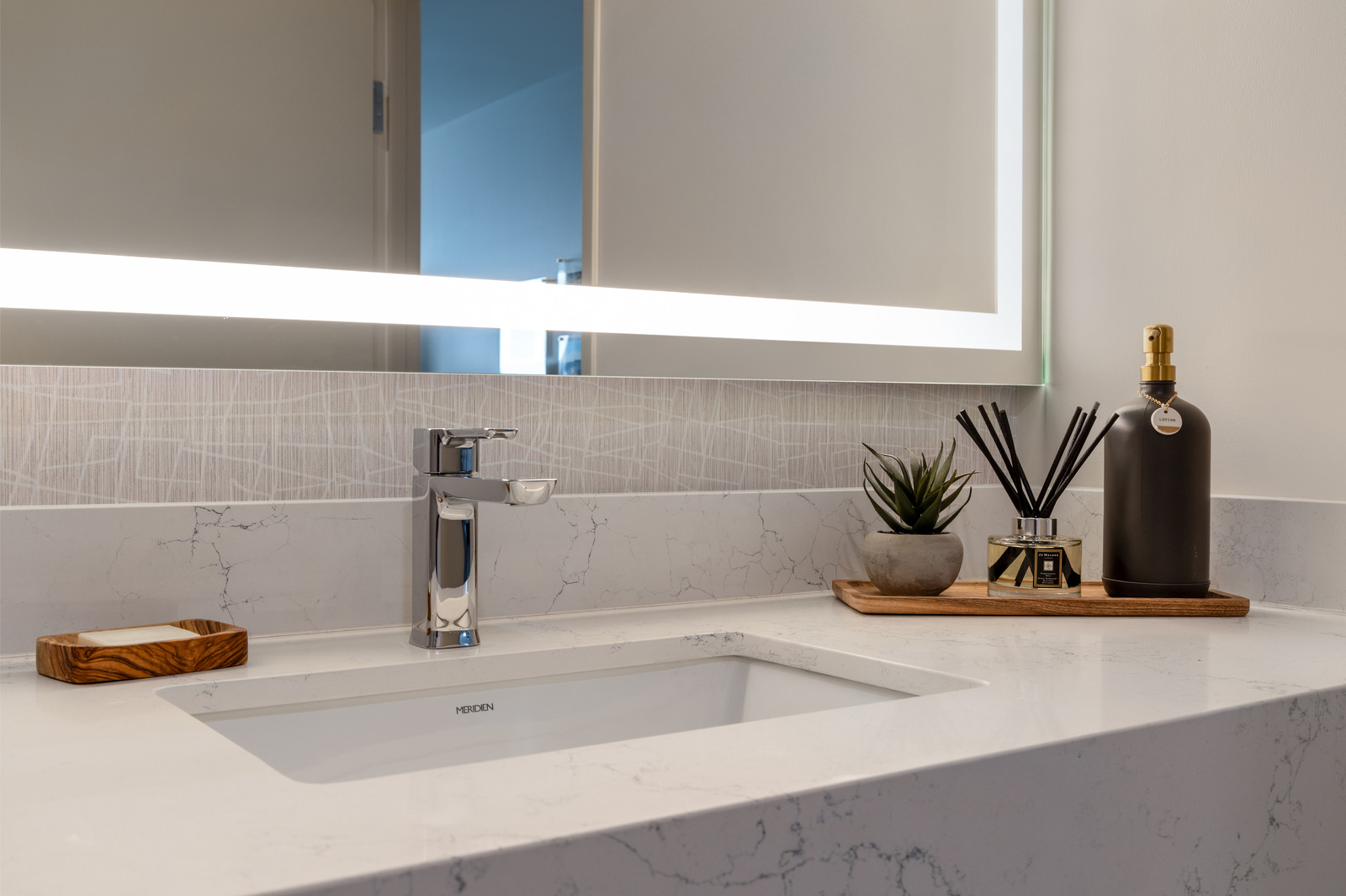 a bathroom sink with a mirror above it