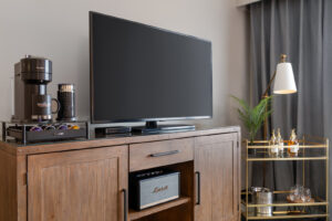 a flat screen tv sitting on top of a wooden cabinet