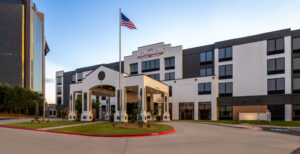 a hotel with a flag flying in front of it