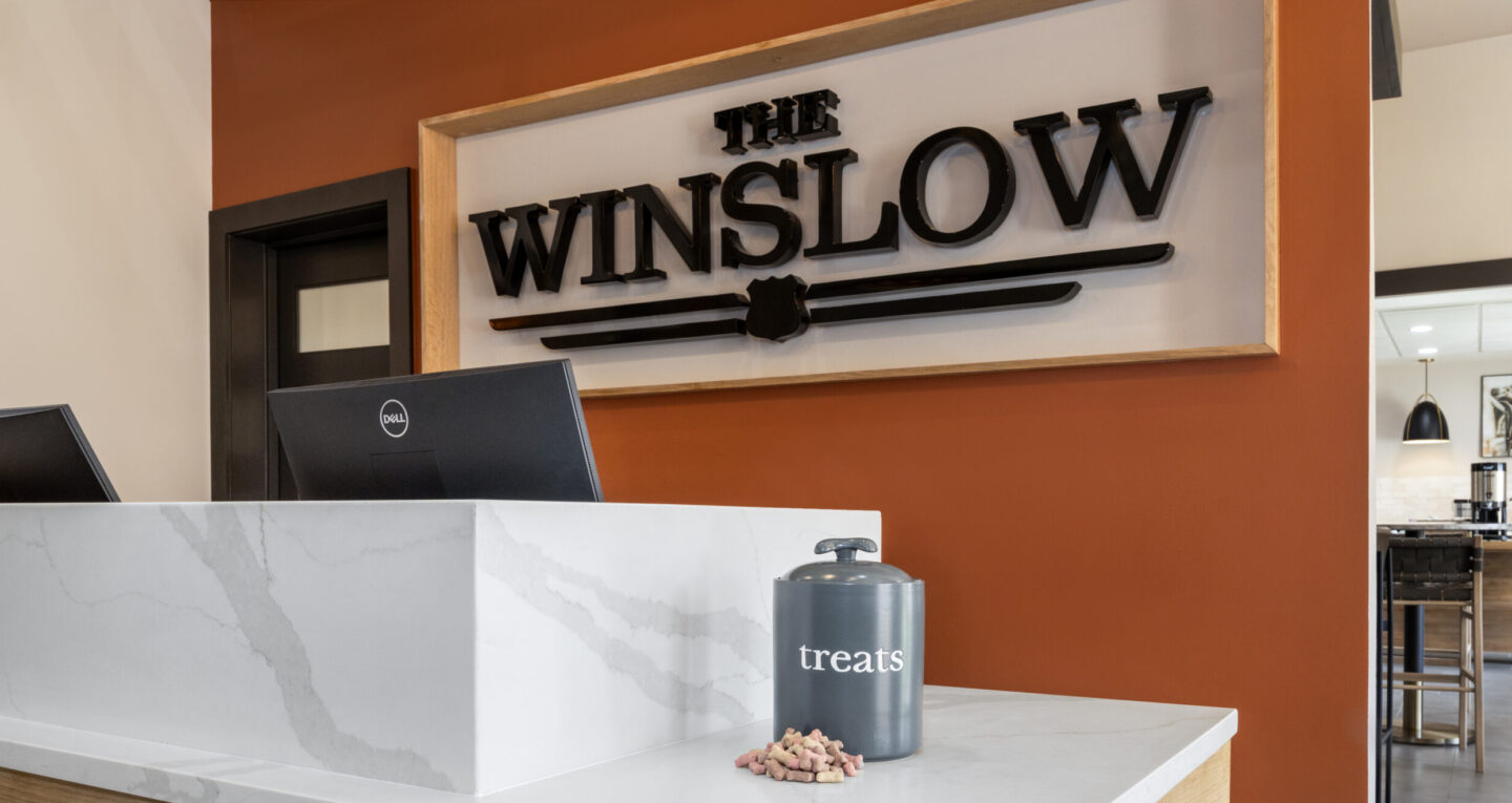 a white counter top sitting under a sign