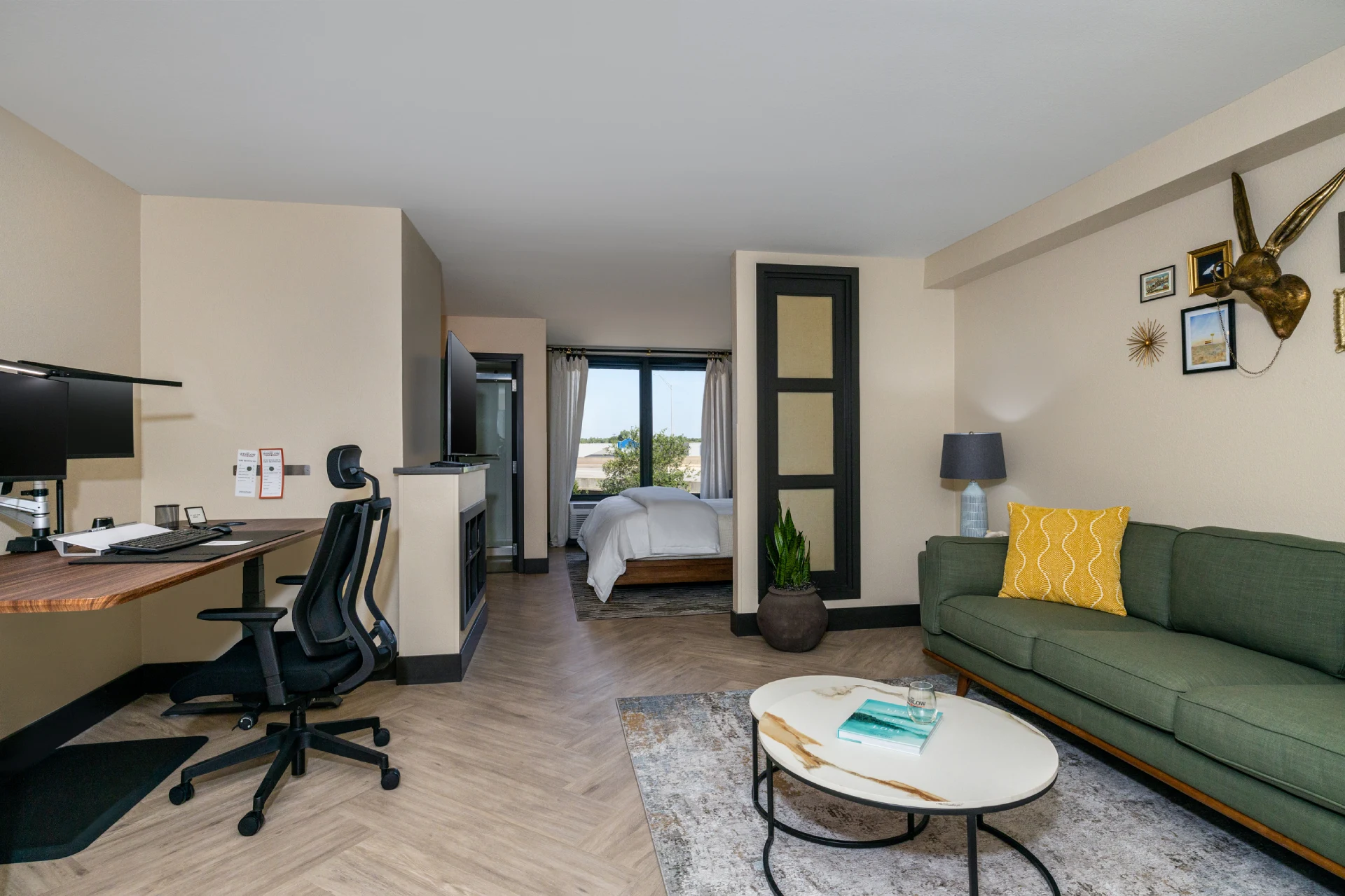 Spacious hotel suites in Oklahoma City with a modern living area, ergonomic desk, and comfortable bedroom.