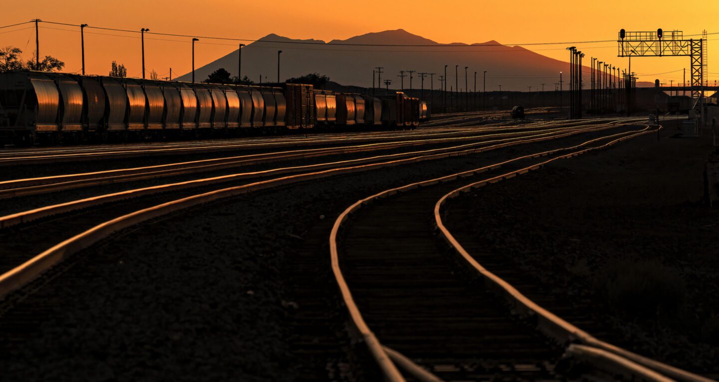 Train in a trainyard during a low sunset near our Winslow, Arizona lodging